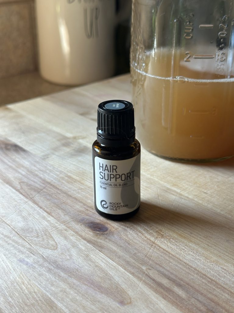 Essential oil for homemade soap nut shampoo sitting on counter