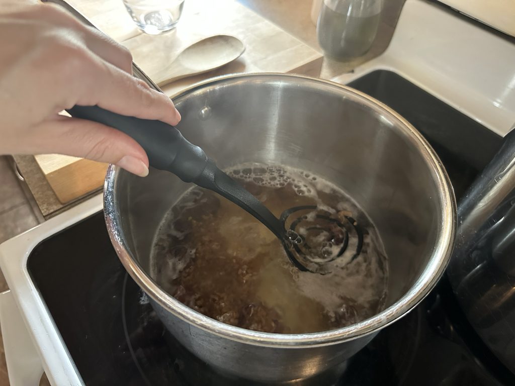 mashing soap nuts in simmer pot on stove