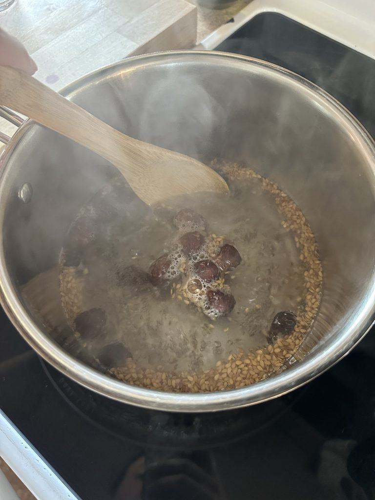 soap nuts being stirred in simmering pot 