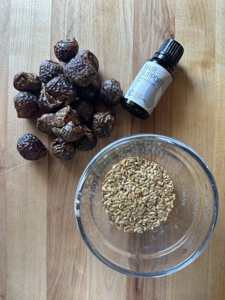 soap nuts sitting on table with flax seeds and essential oils